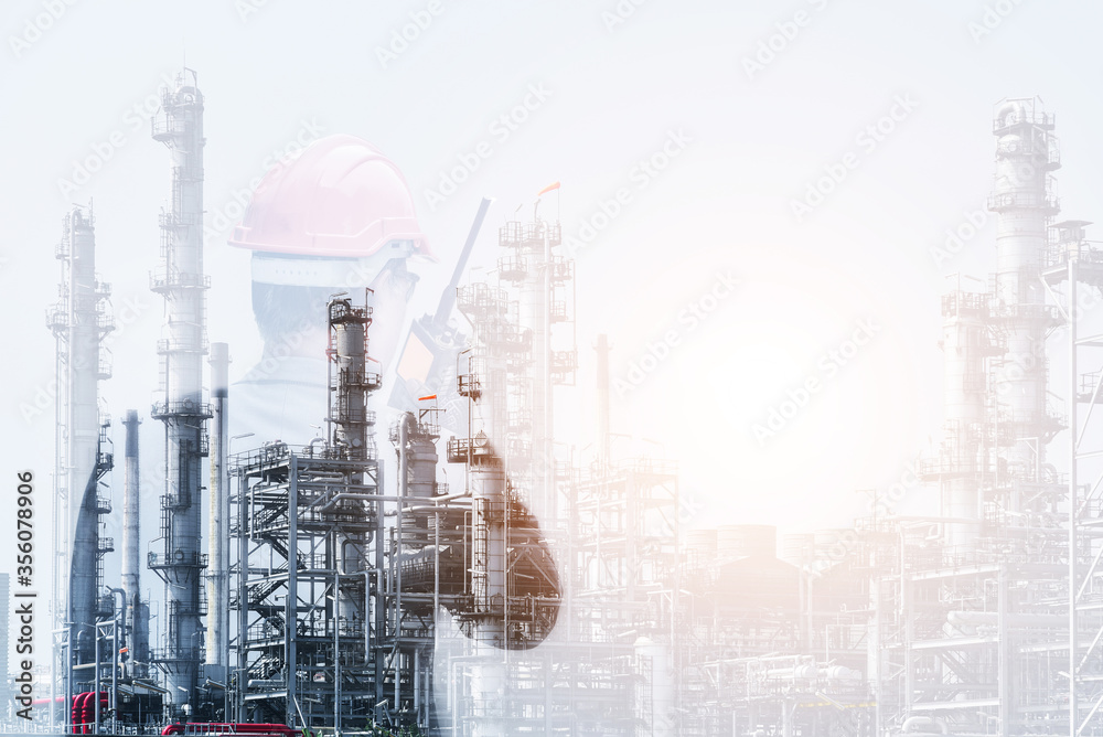 Double Exposure Workers in Oil Refinery plant discussion and pointing for inspection by hand holding Walk-Talkie and wearing hat safety helmet and power plant with refinery plant structure background.