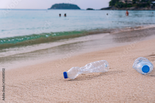Photos Plastic bottles abandoned on the beach. Ecology concept