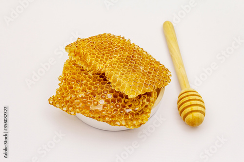Honey, dipper and honeycombs isolated on white background