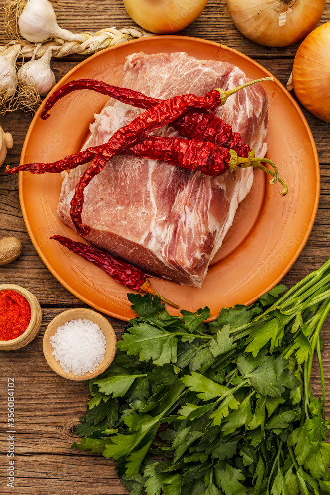 Raw pork meat. Fresh loin, spices, fragrant vegetables and parsley Raw pork meat. Fresh loin, spices, fragrant vegetables and parsley