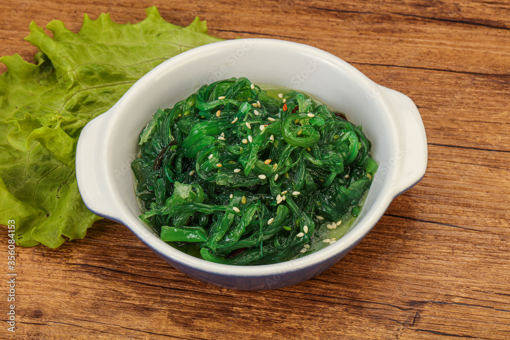 Green Chuka Seaweed Salad Isolated on White Background Top View. Wakame Sea Kelp Salat Green Chuka Seaweed Salad Isolated on White Background Top View. Wakame Sea Kelp Salat