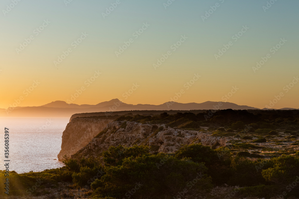 Sunset on the cliffs of Cap Blanc, in the background the bay of Palma, Mallorca Spain