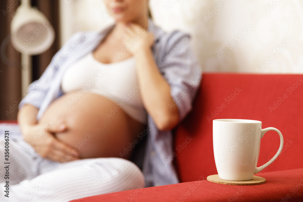 Young pregnant woman with a sore throat Young pregnant woman with a sore throat