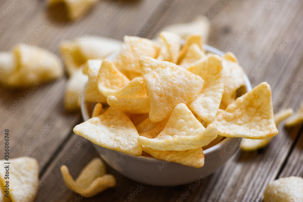 homemade crunchy prawn crackers or shrimp crisp rice - prawn crackers chips on white bowl and wooden table background homemade crunchy prawn crackers or shrimp crisp rice - prawn crackers chips on white bowl and wooden table background