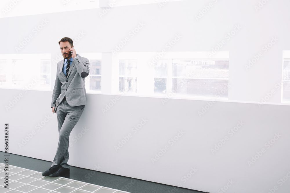 Happy businessman glad to signing contract with new clients, while is standing in hallway company
