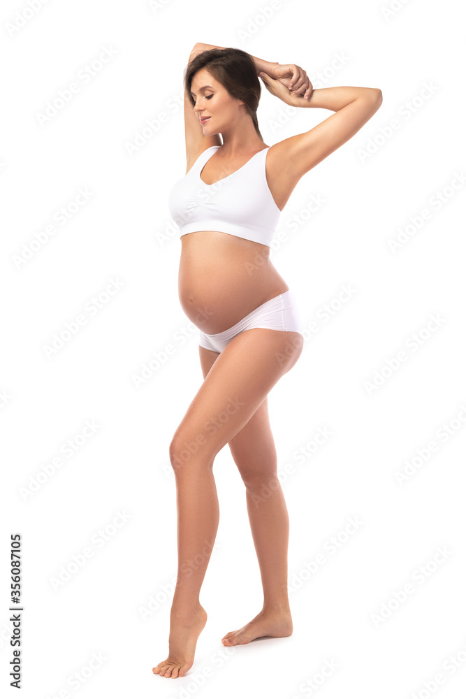 Obraz premium Young and beautiful pregnant woman on white background