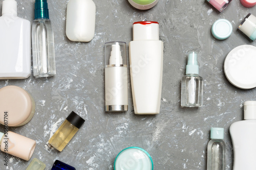 Group of plastic bodycare bottle Flat lay composition with cosmetic products on blue background empty space for you design. Set of White Cosmetic containers, top view with copy space