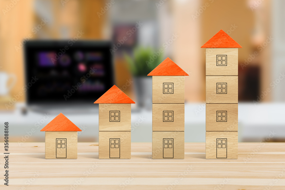 Wood block houses in a growth real estate concept. Wood block houses in a growth real estate concept.