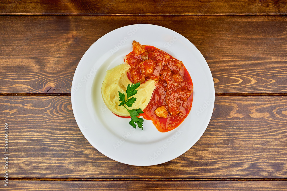 A plate of food on a wooden table A plate of food on a wooden table