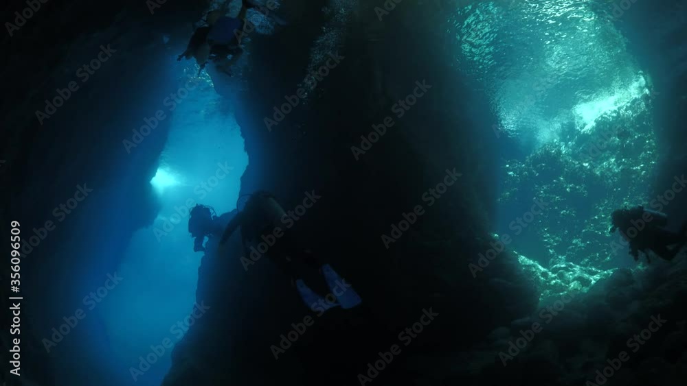 cave diving underwater scuba divers exploring caves ocean scenery sun beams and rays background cave diving underwater scuba divers exploring caves ocean scenery sun beams and rays background