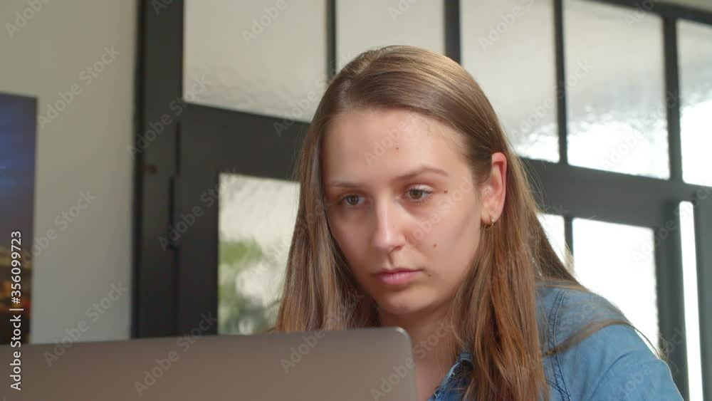 Close Up of Young Business Woman working on Laptop at Office / Typing and Looking to the Screen Close Up of Young Business Woman working on Laptop at Office / Typing and Looking to the Screen