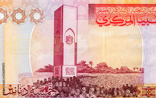 Al-Hani Battle Monument in Tripoli; crowd. Portrait from Libya 5 Dinars 2009 Banknotes. An Old paper banknote, vintage retro. Famous ancient Banknotes. Collection. photo