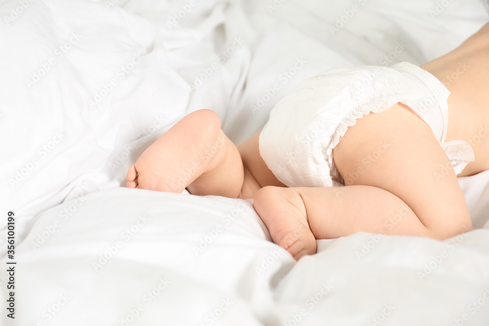 Cute little baby in diaper on bed, closeup Cute little baby in diaper on bed, closeup