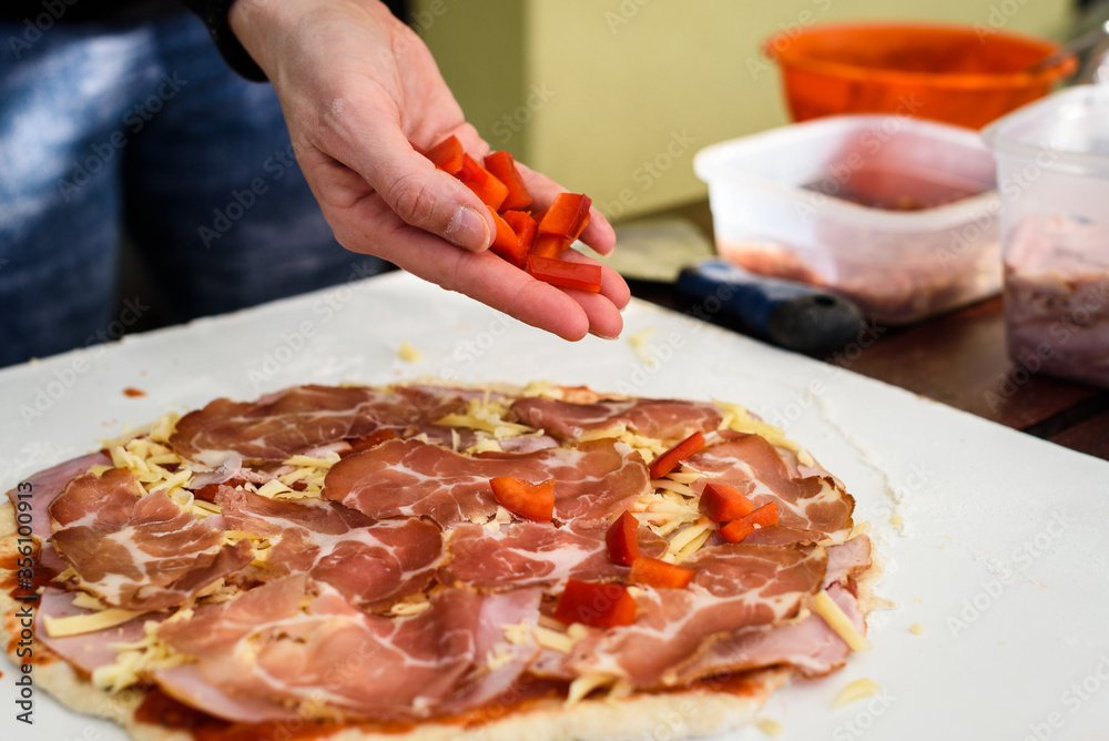 Making of homemade Italian pizza in fireplace brick oven.