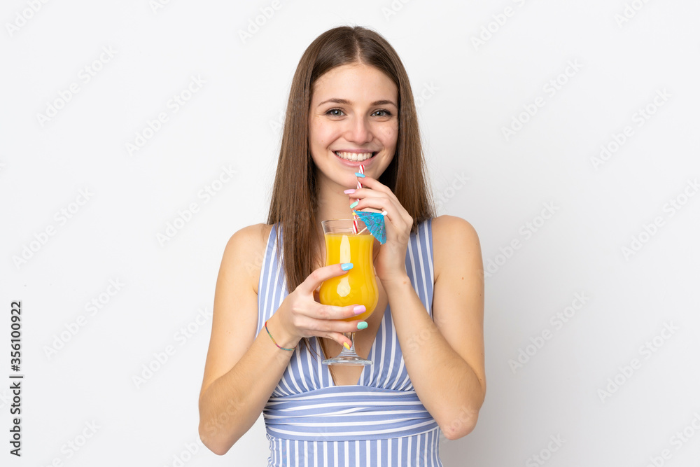 Young caucasian woman isolated on white background in swimsuit and holding a cocktail Young caucasian woman isolated on white background in swimsuit and holding a cocktail