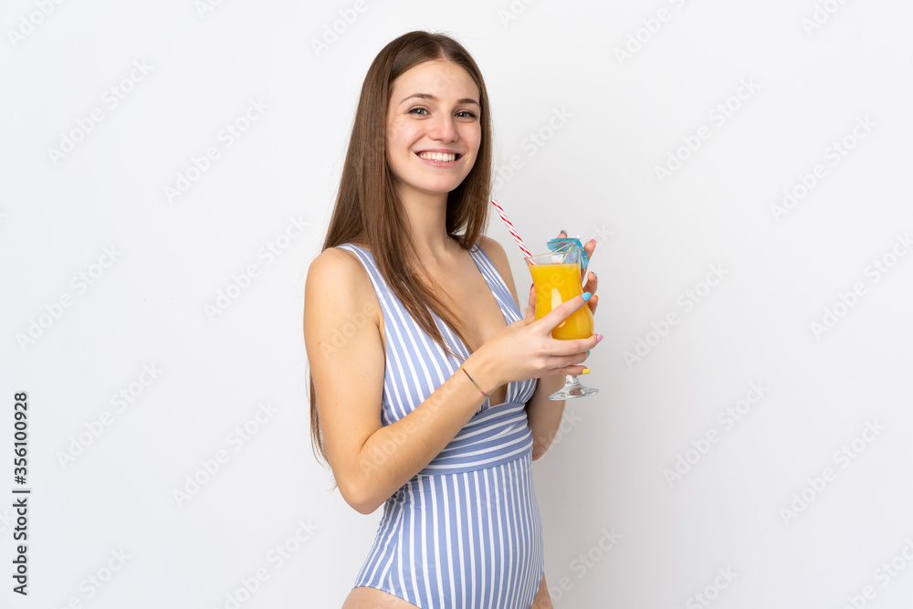 Young caucasian woman isolated on white background in swimsuit and holding a cocktail Young caucasian woman isolated on white background in swimsuit and holding a cocktail