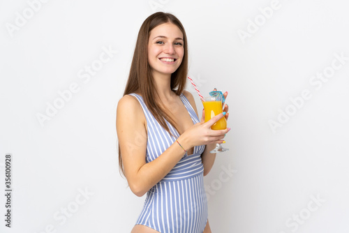 Young caucasian woman isolated on white background in swimsuit and holding a cocktail