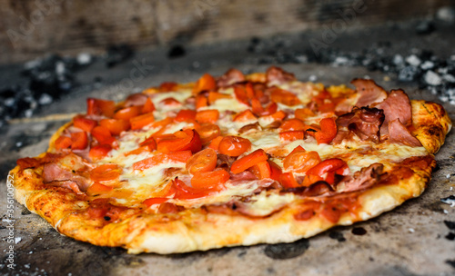 Making of homemade Italian pizza in fireplace brick oven.