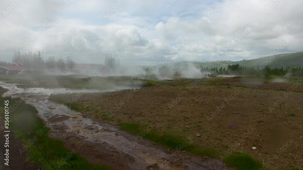 Smoke rising in active geothermal spring formation and from geyser field site on sunny day, close up pan Smoke rising in active geothermal spring formation and from geyser field site on sunny day, close up pan
