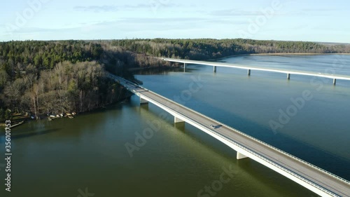 Two highway bridges over river; two lanes, one direction each; low traffic in Sweden; highway E18 from Stockholm to Enköping. Aerial view, parallel flight back photo