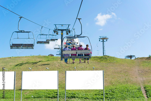 Chair lifts with people. View on summer. Holiday and vacation.