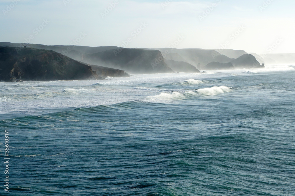 Fototapeta premium waves rolling against cliffs at Portugals Wild West coast