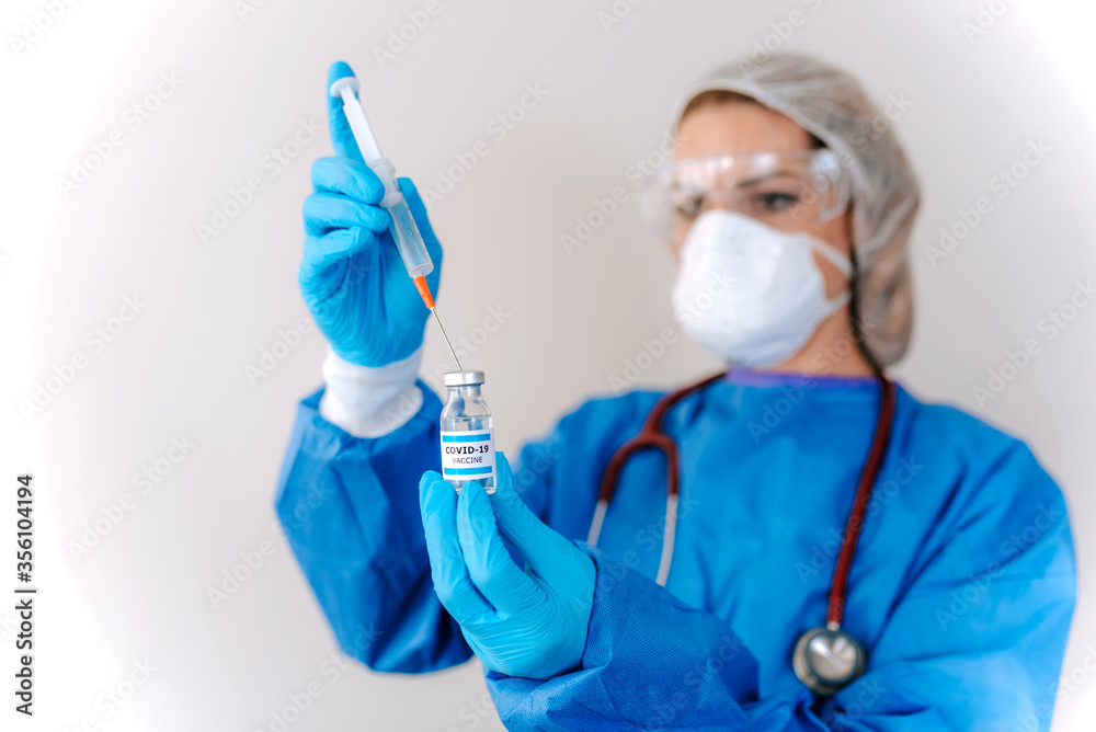 COVID-19 Coronavirus Vaccine. Doctor scientist analyzing virus Sars-CoV-2 in research for vaccine to be ready for clinical trial. Female researcher testing potential vaccine at the lab. COVID-19 Coronavirus Vaccine. Doctor scientist analyzing virus Sars-CoV-2 in research for vaccine to be ready for clinical trial. Female researcher testing potential vaccine at the lab.