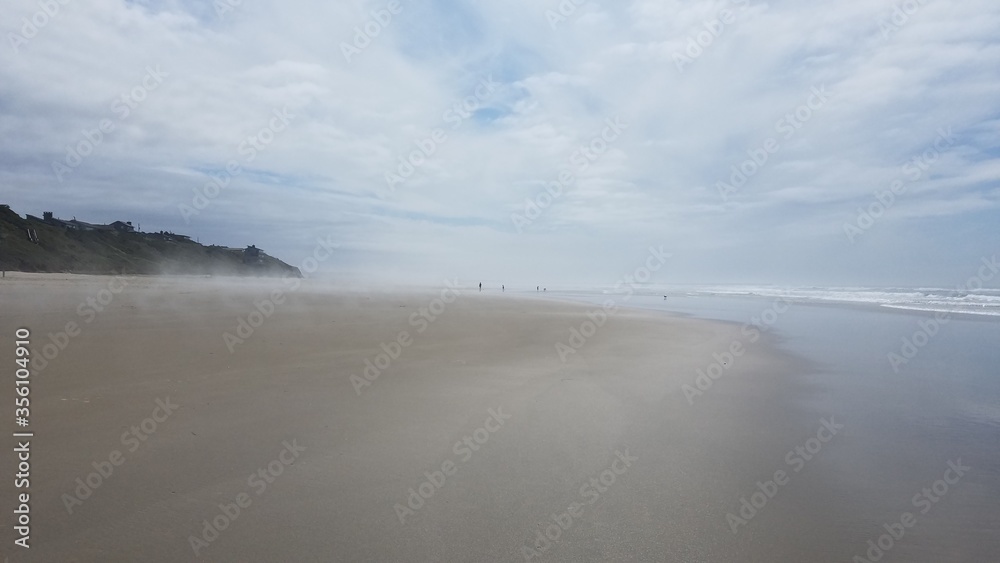 ocean water and sand at the beach in Newport, Oregon
