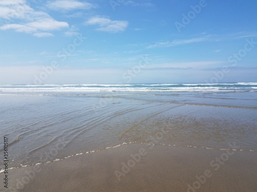 ocean water and sand at the beach in Newport, Oregon