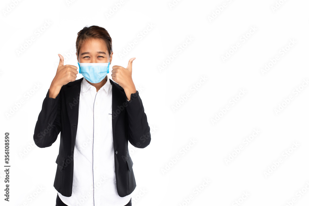 Asian businesswoman wearing surgical face mask in formal black suit jacket, looking at camera, showing two hand thumbs up, studio lighting isolated on white background, coronavirus, COVID19 concept Asian businesswoman wearing surgical face mask in formal black suit jacket, looking at camera, showing two hand thumbs up, studio lighting isolated on white background, coronavirus, COVID19 concept