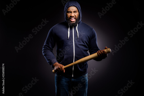 Photo of furious afro amercan guy hold baseball beat ready fight for african community solidarity rights wear sweater jumper denim jeans isolated black color background photo