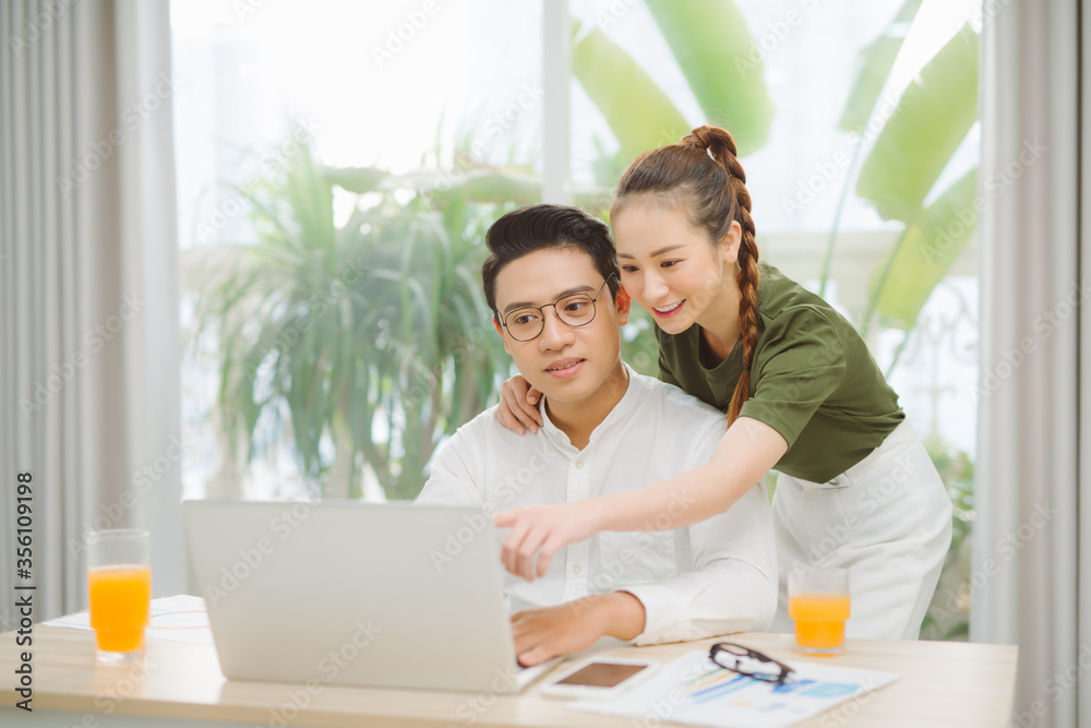 Couple at home websurfing on internet Couple at home websurfing on internet