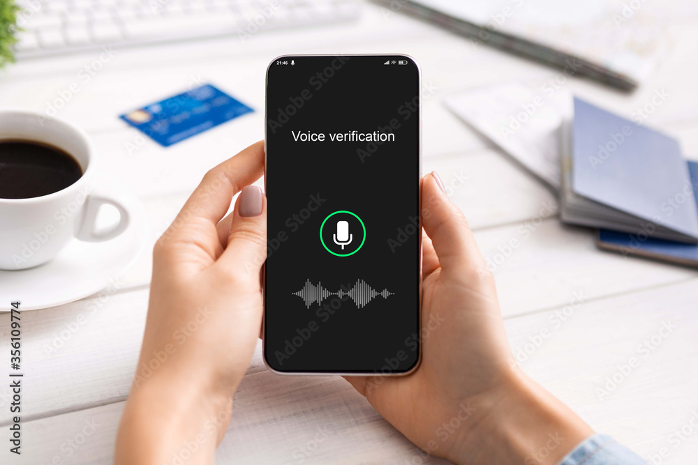 Female Hands Holding Smartphone Using Voice Recognition App Sitting Indoors Female Hands Holding Smartphone Using Voice Recognition App Sitting Indoors