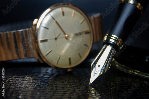 Fountain pen and antique watch