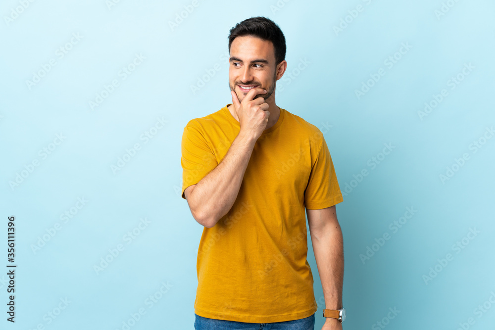 Young handsome man over isolated background looking to the side and smiling Young handsome man over isolated background looking to the side and smiling