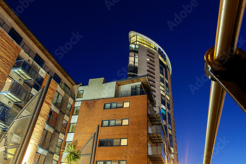 Modern high rise apartment building at night - low angle view.  photo