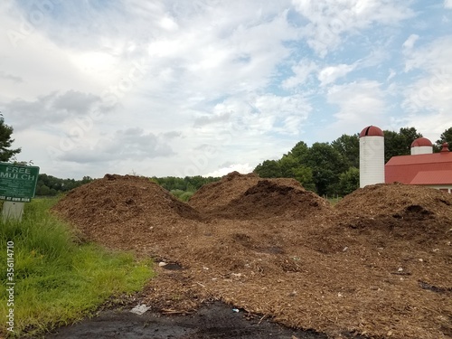 large pile of mulch and silo
