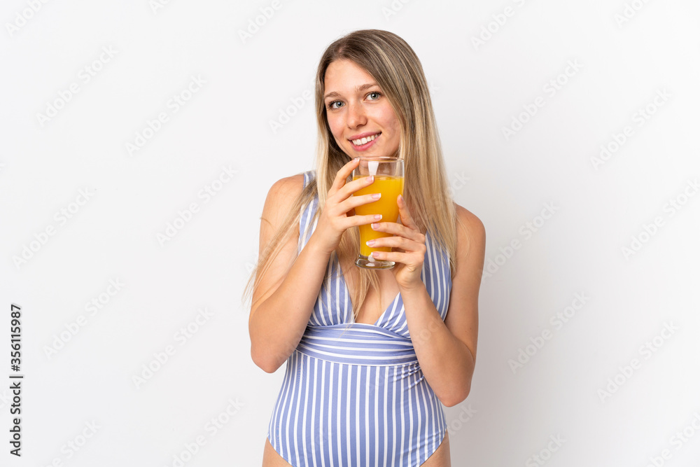 Young blonde woman isolated on white background in swimsuit and holding a cocktail Young blonde woman isolated on white background in swimsuit and holding a cocktail