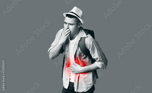 Monochrome photo of male tourist having food poisoning photo