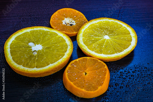 a beautiful close up view of an orange slice with beautiful background, vitamin C, covid 19a beautiful close up view of wet orange slices with beautiful background, vitamin C, covid 19