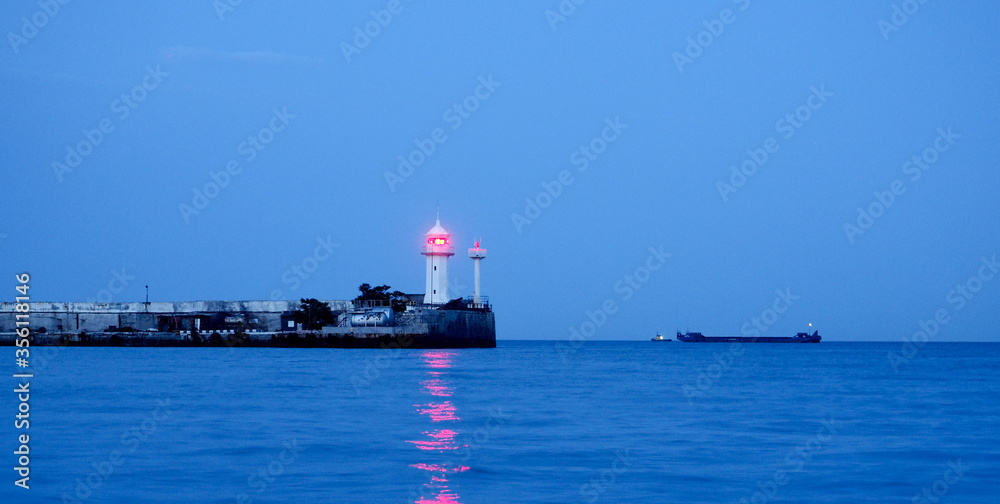 banner lighthouse at sunset in the twilight in clear weather in Crimea