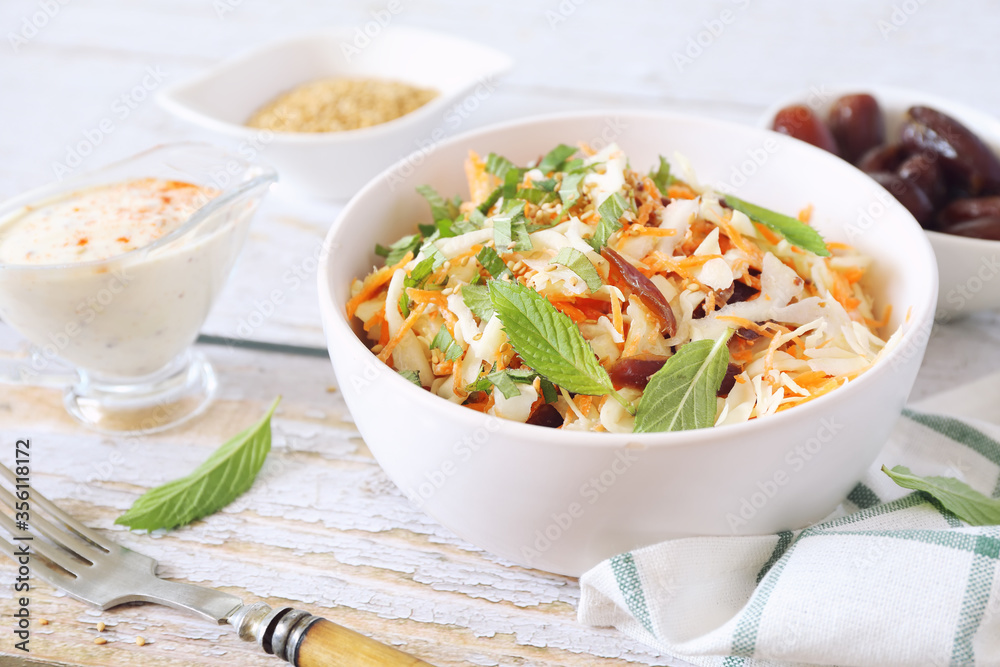 Coleslaw salad with carrots, dates and sauce for diet food, mint leaves dressing Coleslaw salad with carrots, dates and sauce for diet food, mint leaves dressing