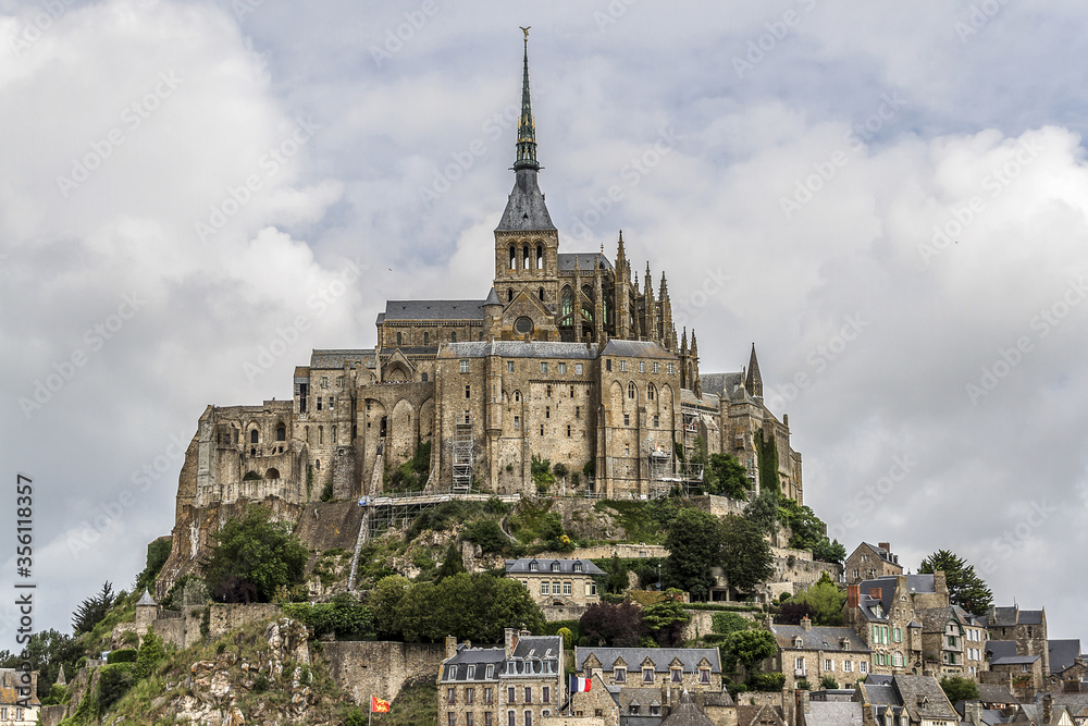 Obraz premium Abbey Mont Saint-Michel (VII century) at rocky tidal island in Normandy - one of most visited tourist sites in France. Normandy, Northern France, Europe.