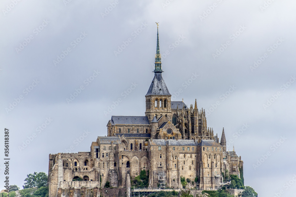 Abbey Mont Saint-Michel (VII century) at rocky tidal island in Normandy - one of most visited tourist sites in France. Normandy, Northern France, Europe.