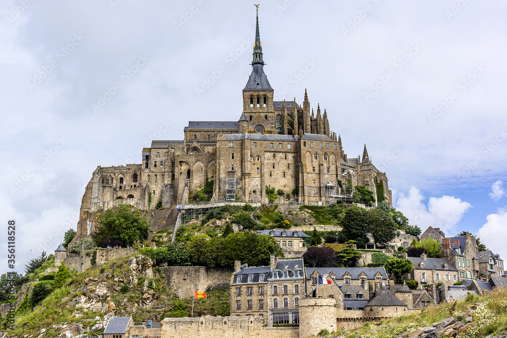 Obraz premium Abbey Mont Saint-Michel (VII century) at rocky tidal island in Normandy - one of most visited tourist sites in France. Normandy, Northern France, Europe.