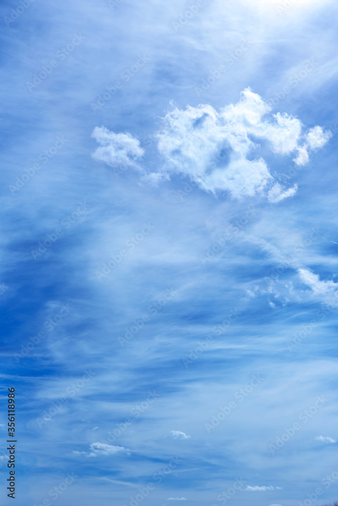 Obraz premium Blue sky background with single white cloud.