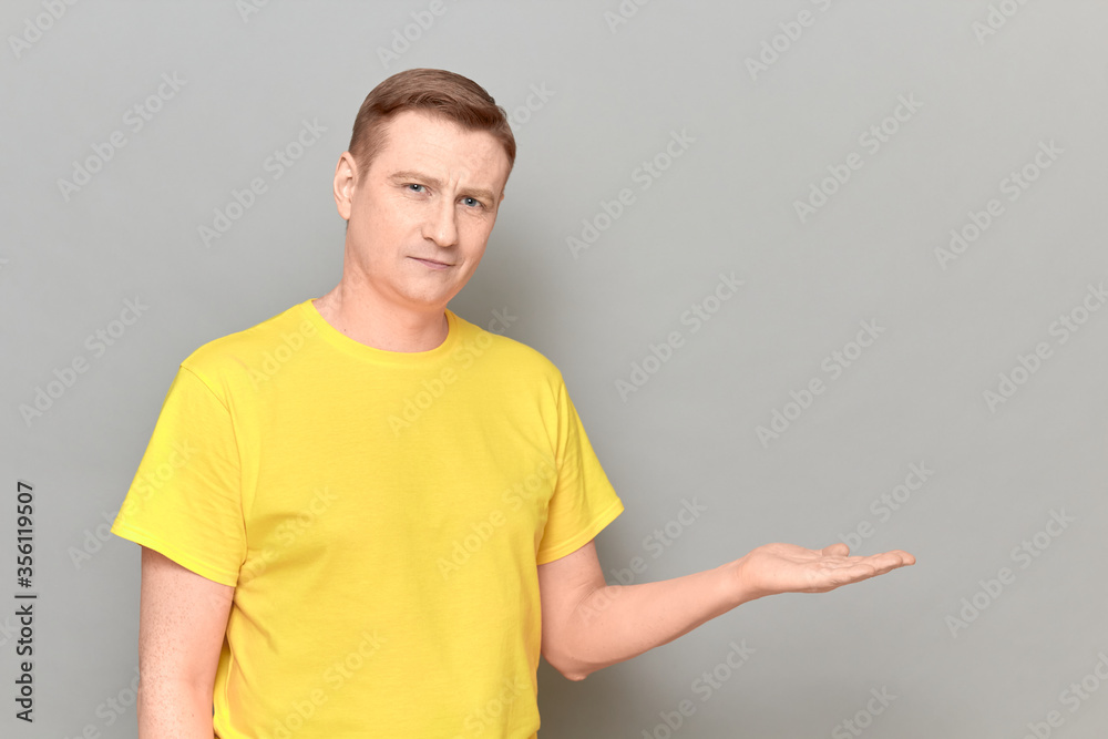 Portrait of happy man showing copy space over open palm and smiling Portrait of happy man showing copy space over open palm and smiling