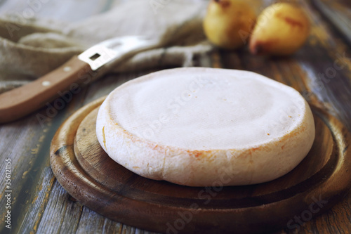 French Reblochon cheese and two yellow pears