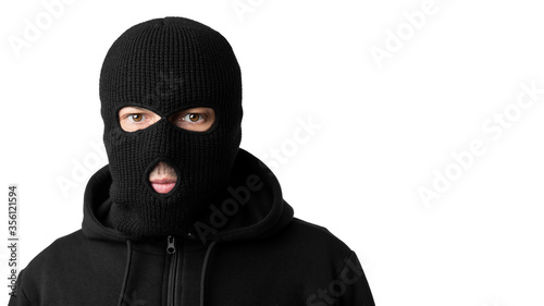 Portrait of masked thief isolated over white wall photo