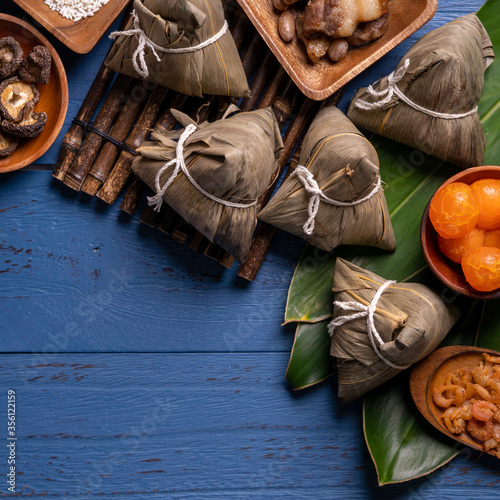 zongzi - Dragon Boat Festival concept Rice dumpling, traditional Chinese food on blue wooden background for Duanwu Festival, top view, flat lay design concept.